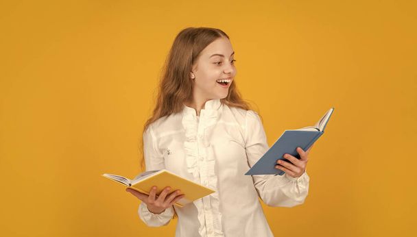 back to school. kid ready to study. happy childhood. child going to do homework reading book. surprised teenager student. education in high school. schoolgirl with copybook. teen girl with notebook. - Foto, Imagen