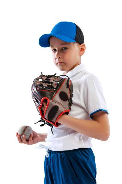 Portrait of kid, beginner baseball player in sports uniform posing with baseball glove isolated on white background. Concept of sport, achievements, competition. Future champion - Фото, изображение