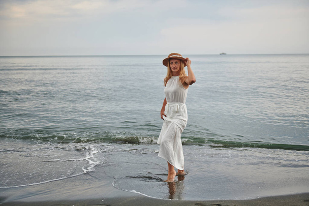 white hat and dress at the girl at the sea. High quality photo - Fotoğraf, Görsel