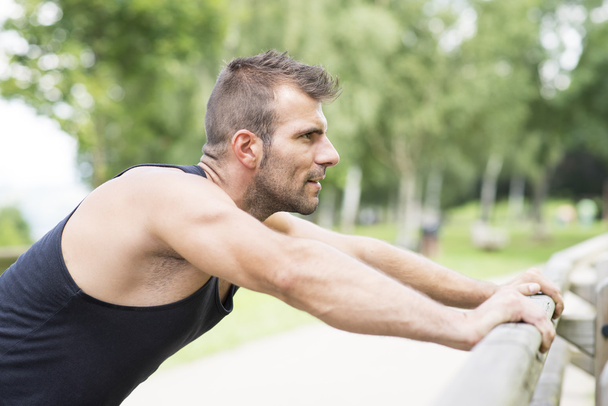 Portrait of athletic man doing pushups, outdoor. - Photo, Image