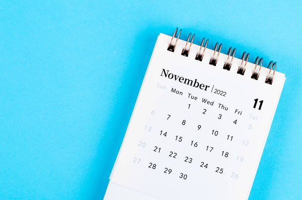 The mini November 2022 desk calendar on blue background. - Fotografie, Obrázek