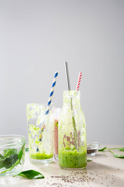 Glass and bottle after healthy green vegan smoohie food concept - Photo, Image
