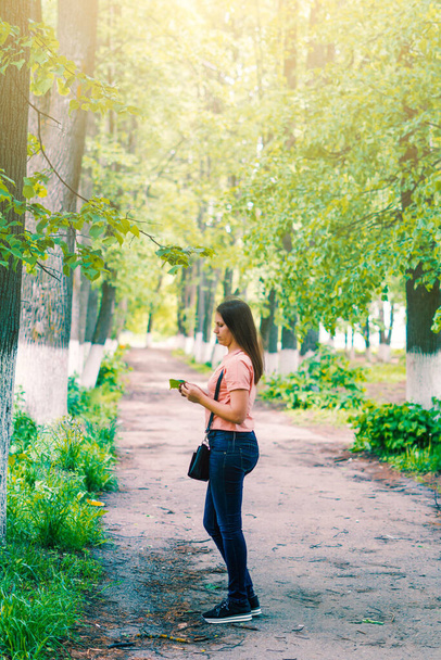 A close up of a beautiful woman walking through a forest on a beautiful summer day - Fotoğraf, Görsel