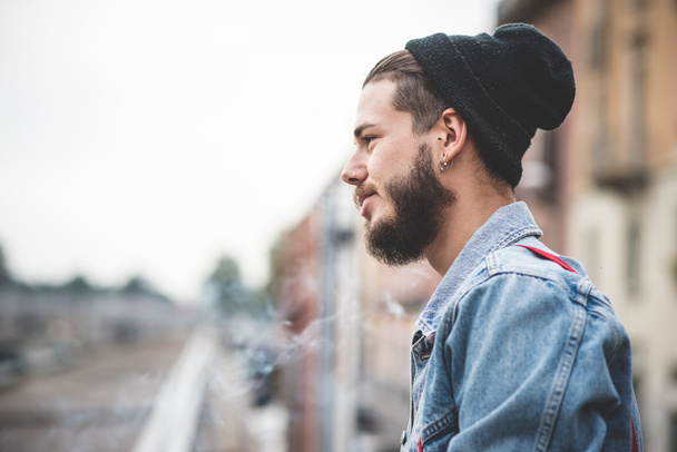 fiatal jóképű szakállas csípő ember dohányzás cigaretta - Fotó, kép