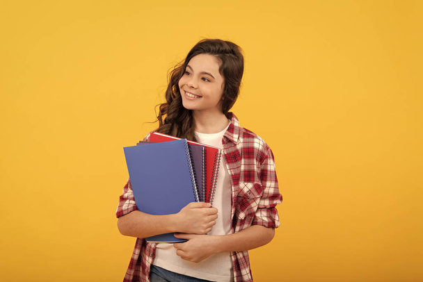 schoolgirl with notebook. back to school. teen girl ready to study. happy childhood. cheerful kid going to do homework with books. smiling student. education and knowledge. high school. - Photo, Image
