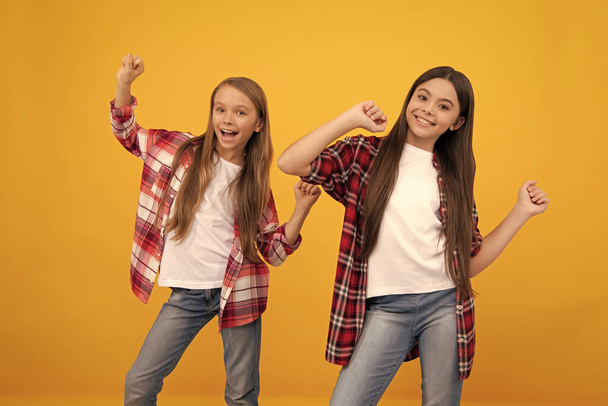 happy kids in casual checkered shirt having fun on yellow background, friendship. - Photo, Image