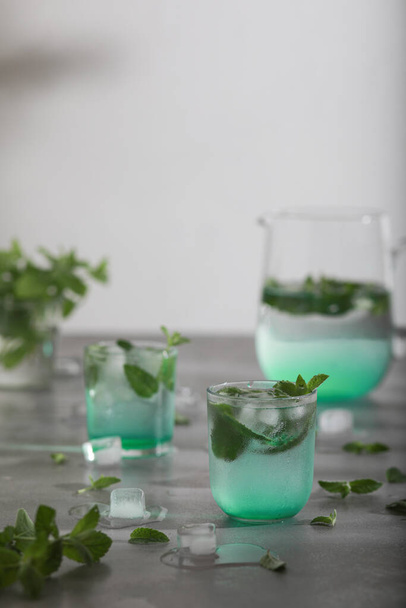 Glass of cold water with fresh mint leaves and ice cubes. Copy space - Photo, Image