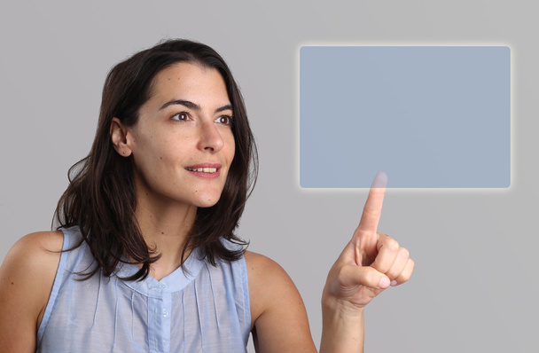 Young woman activating a virtual screen - Photo, image