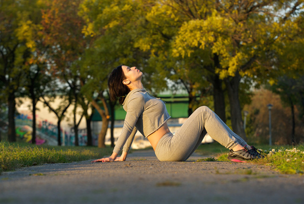 Sports woman sitting in park relaxing - Photo, image