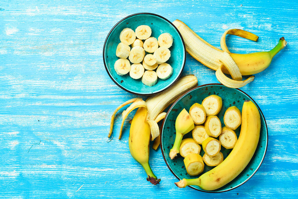 Tropical bananas on a blue wooden background. Top view. - Foto, Imagen