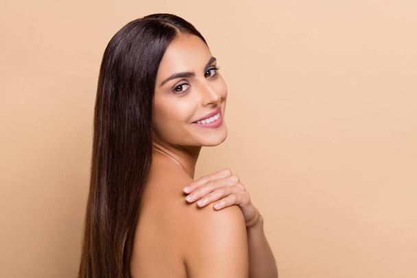 Profile side view portrait of attractive cheery girl washing pure flawless skin balm isolated over beige pastel color background. - Fotoğraf, Görsel