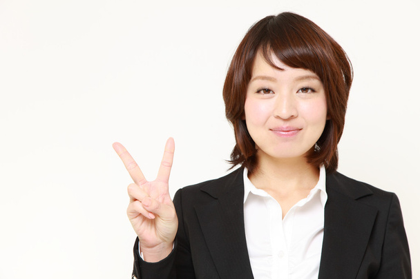 Japanese Businesswoman showing a victory sign - Φωτογραφία, εικόνα