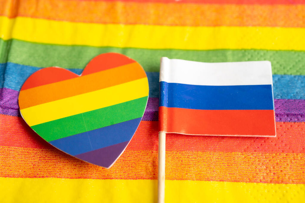 Russia flag on rainbow background symbol of LGBT gay pride month  social movement rainbow flag is a symbol of lesbian, gay, bisexual, transgender, human rights, tolerance and peace. - Photo, Image