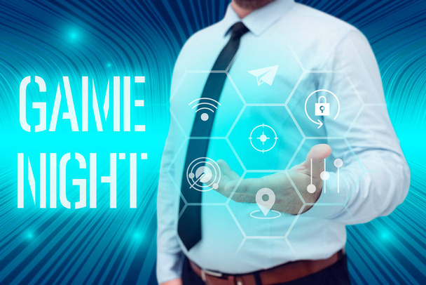Text sign showing Game Night, Business concept event in which folks get together for the purpose of getting laid Businessman in suit holding open palm symbolizing successful teamwork. - Photo, Image