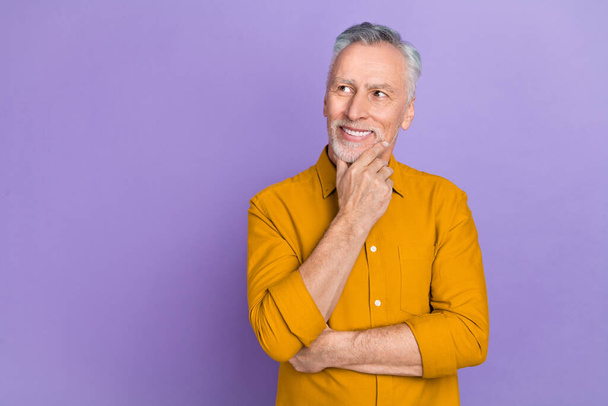 Photo of smart old white hairdo man hand face look empty space wear yellow shirt isolated on purple color background. - Valokuva, kuva