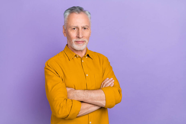 Photo of nice aged grey hairdo man crossed arms wear yellow shirt isolated on purple color background. - Photo, Image