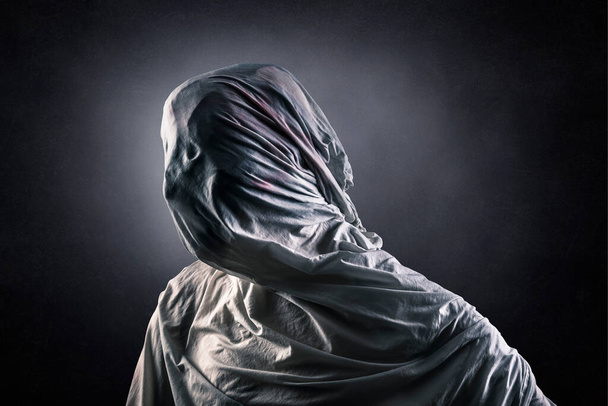Portrait of a scary ghost over dark misty background - 写真・画像