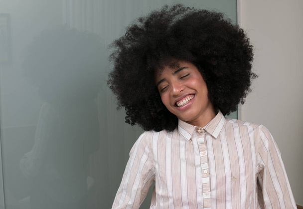 Young woman with beautiful big hair giving a big simile - Foto, immagini