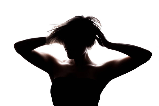 Silhouette portrait of a girl with short hair and hands up. Isolated against white background - Φωτογραφία, εικόνα