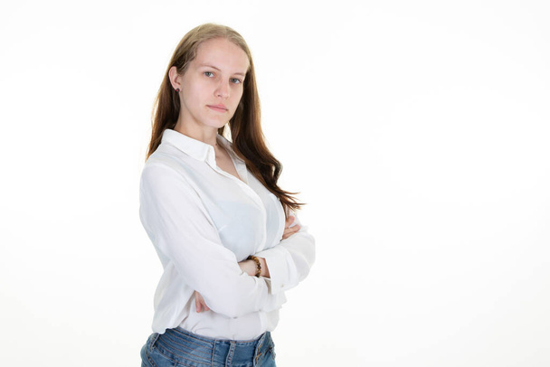 young pretty woman in white shirt posing isolated in white background arms crossed - Фото, зображення