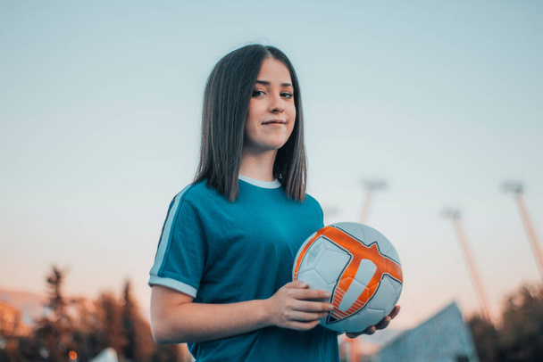 A beautiful female football player posing on the football pitch - Zdjęcie, obraz