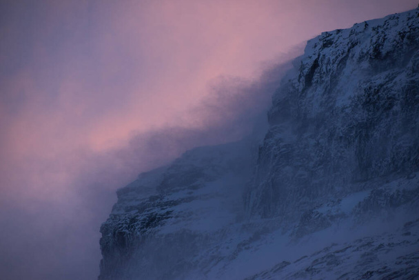 A closeup shot of a snowy mountain with fog on the side - Fotografie, Obrázek