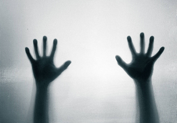 Horror, halloween background - Shadowy figure hands behind glass - Foto, afbeelding