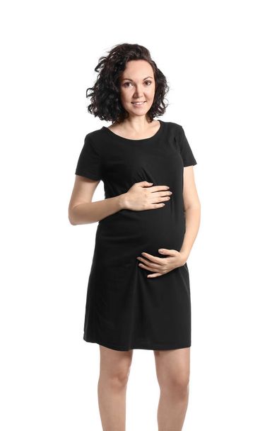 Mladá těhotná žena v černých šatech na bílém pozadí - Fotografie, Obrázek