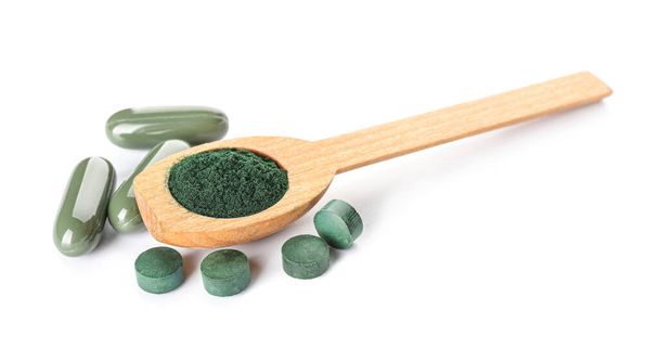 Wooden spoon with spirulina powder and pills isolated on white background - Photo, Image