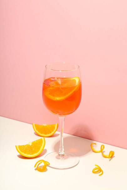 Concept of fresh alcohol drink, Aperol Spritz on two tone background - Фото, изображение