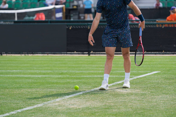 The tennis player getting ready to serve. Nottingham, United Kingdom. - Фото, зображення