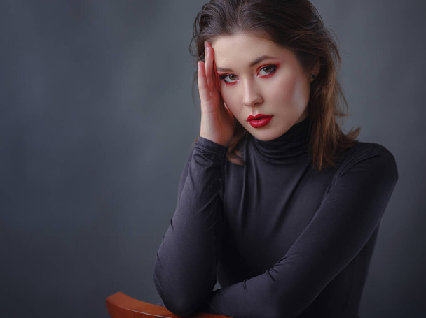seductive asian woman with red lips in black turtleneck isolated on dark grey. The concept of beauty and health. - Fotoğraf, Görsel