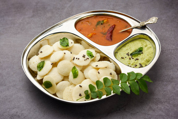 Mini idli is the smaller version of soft and spongy round shaped steamed regular rice idli, also known as button and cocktail idly - Photo, Image