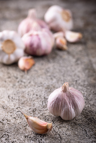 Fresh organic garlic on stone table background - Fotó, kép