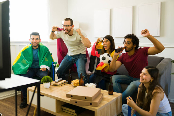 Les fans de sport joyeux se sentent excités et célèbrent après tout en regardant leur équipe de football gagner à la télévision - Photo, image