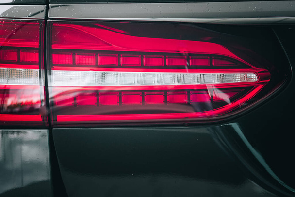 A closeup of the brake light of a black luxury car - Foto, Imagem