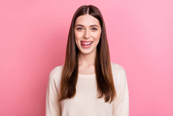 Portrait of attractive cheerful brown haired funky girl licking lip isolated over pink pastel color background. - Foto, Imagen