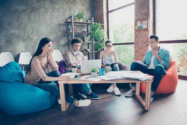 Full size photo of group intelligent people sitting beanbag studying prepare exam loft office indoors. - Φωτογραφία, εικόνα