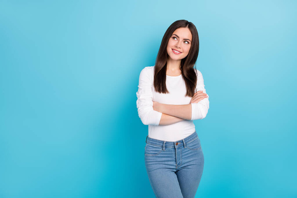 Portrait of attractive minded cheerful brunet girl assistant folded arms making solution isolated over vivid blue color background. - Foto, Imagen
