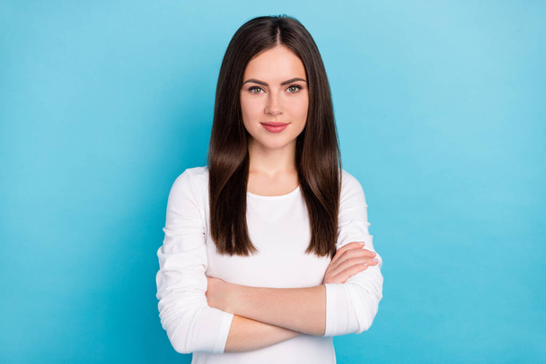 Portrait of attractive content successful brunet girl assistant folded arms isolated over vibrant blue color background. - Fotó, kép