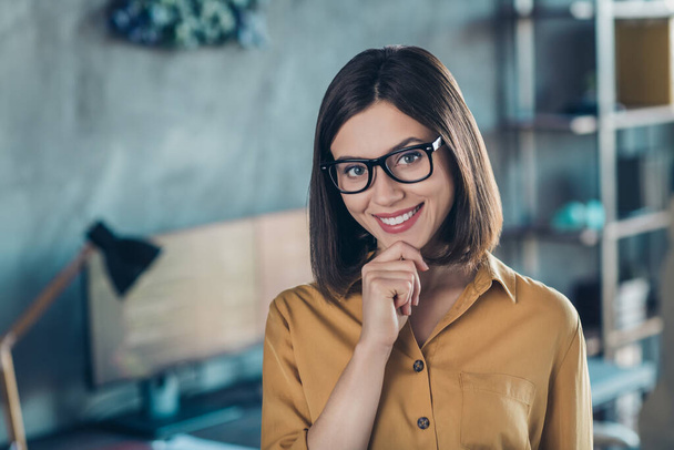 Portrait of attractive skilled cheerful girl nerd geek touching chin tech network workshop at workplace workstation indoors. - Foto, Bild