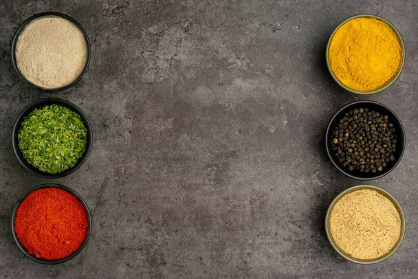 High quality close up photo of various spices with a dramatic concept for cooking food on dark background, close up, top view. - Φωτογραφία, εικόνα