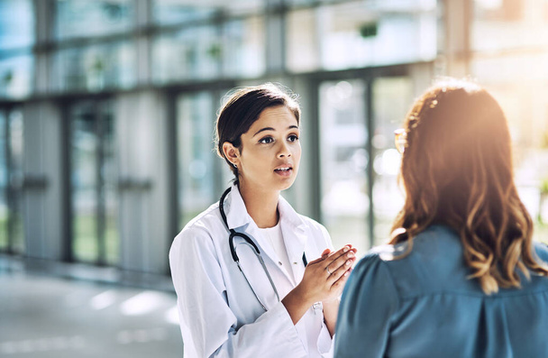 Cropped shot of a female doctor talking to a patient. - Foto, imagen