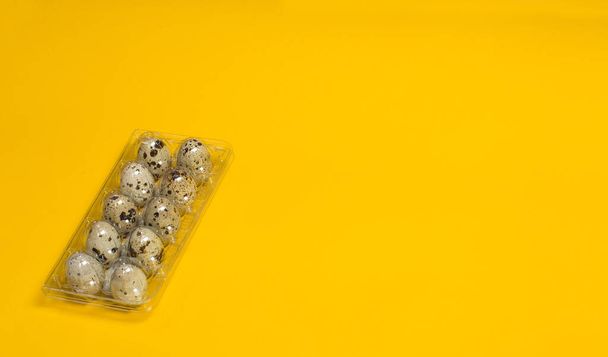 Small quail eggs on a yellow background, healthy food - Фото, изображение