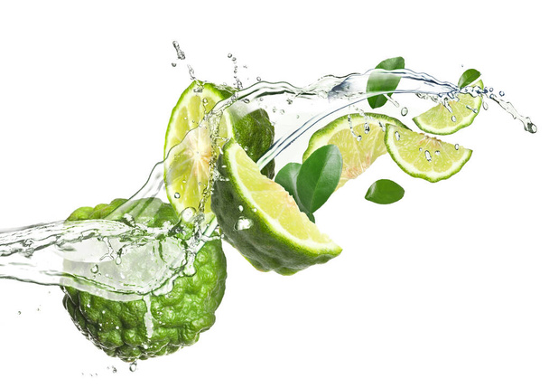 Fresh ripe bergamot fruits, green leaves and splashing water on white background - Φωτογραφία, εικόνα