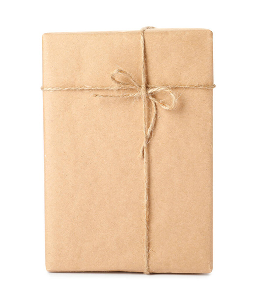 Parcel wrapped with kraft paper and twine isolated on white - Foto, Imagen