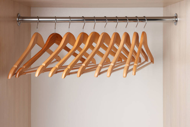 Set of clothes hangers on wardrobe rail - Fotografie, Obrázek