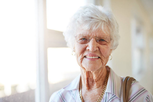 Portret van een gelukkige oudere vrouw die zich klaarmaakt om uit te gaan. - Foto, afbeelding