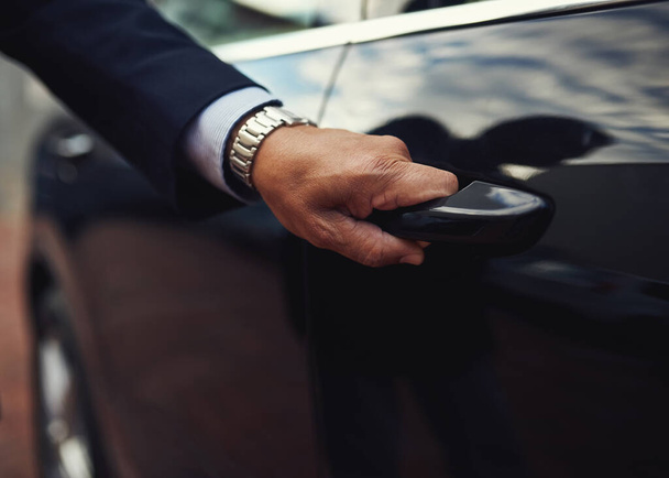 Cropped shot of a businessman opening a car door. - Foto, immagini