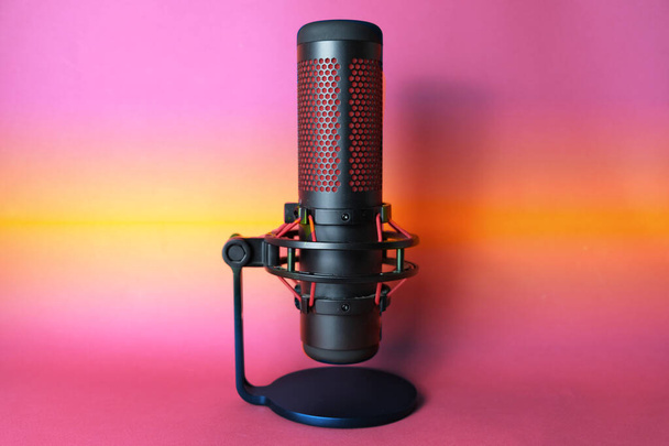 Microphone for podcasts and sound recording. Studio condenser microphone for advertising and sound recording. Black color with red accents, side view with space for text. - Fotó, kép